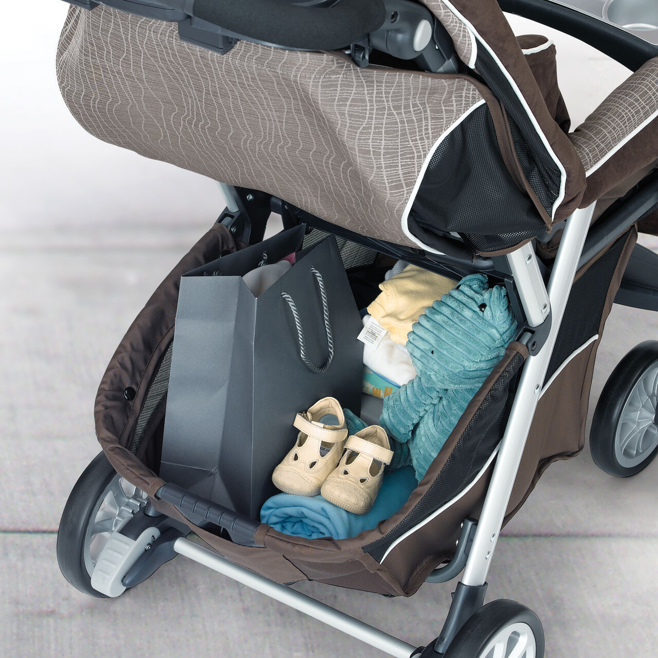 Spacious storage basket on the Cortina Magic Stroller, part of the Chicco Cortina travel system rattania image number 2