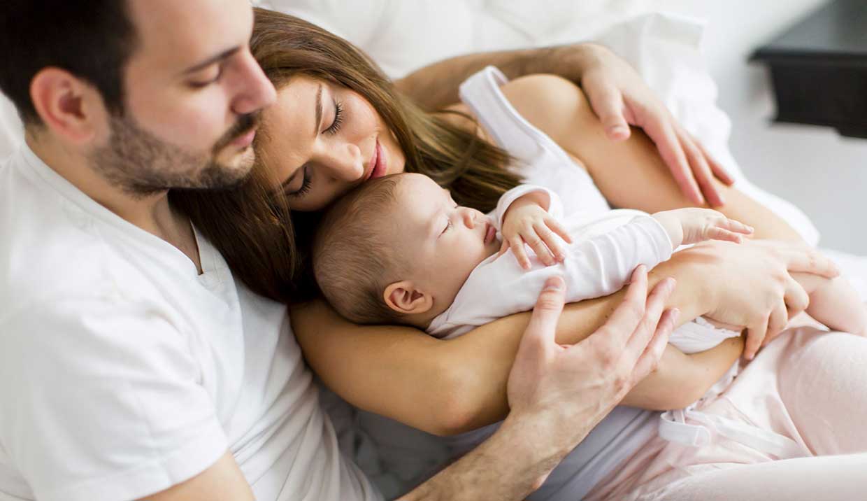 Family with sleeping baby