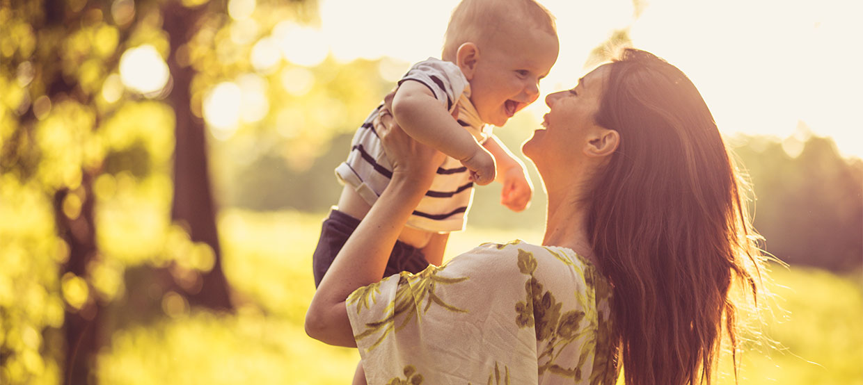 Mother with child in field image