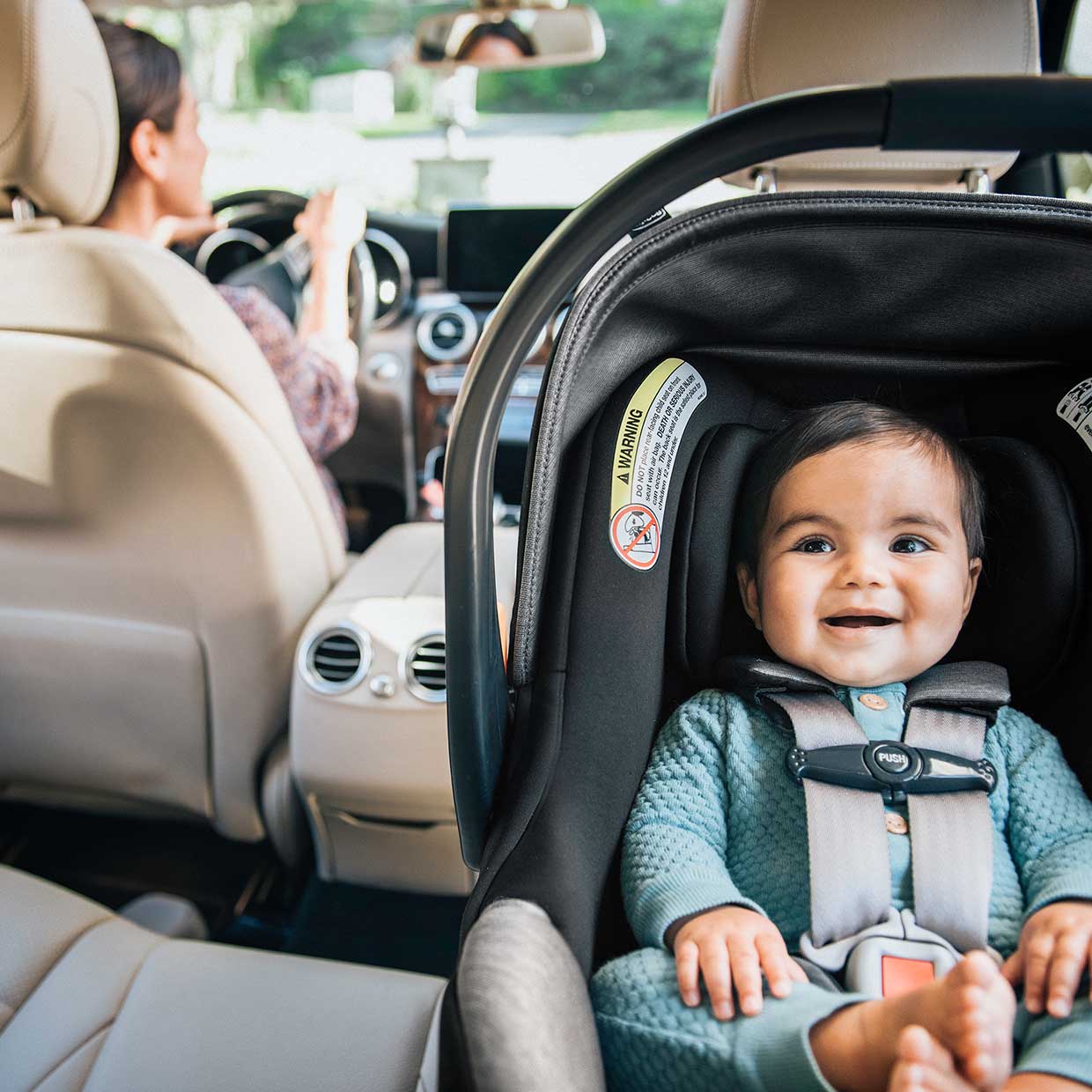 Baby sitting in a Chicco KeyFit Max Infant Car Seat in rear-facing mode