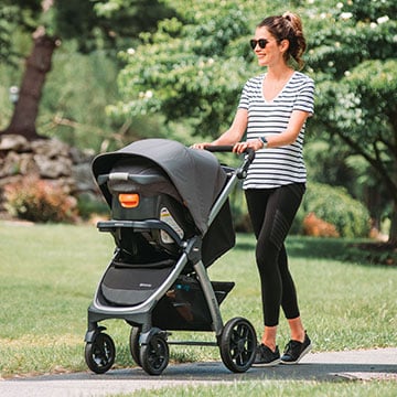Mother using the Chicco Bravo Stroller Travel System