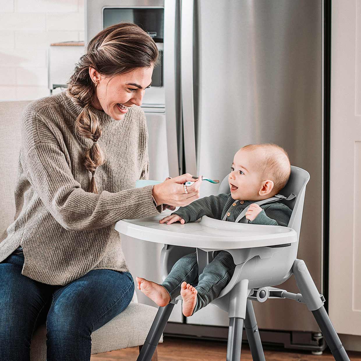 Mother feeding Infant in Chicco Zest 4-in-1 High Chair image