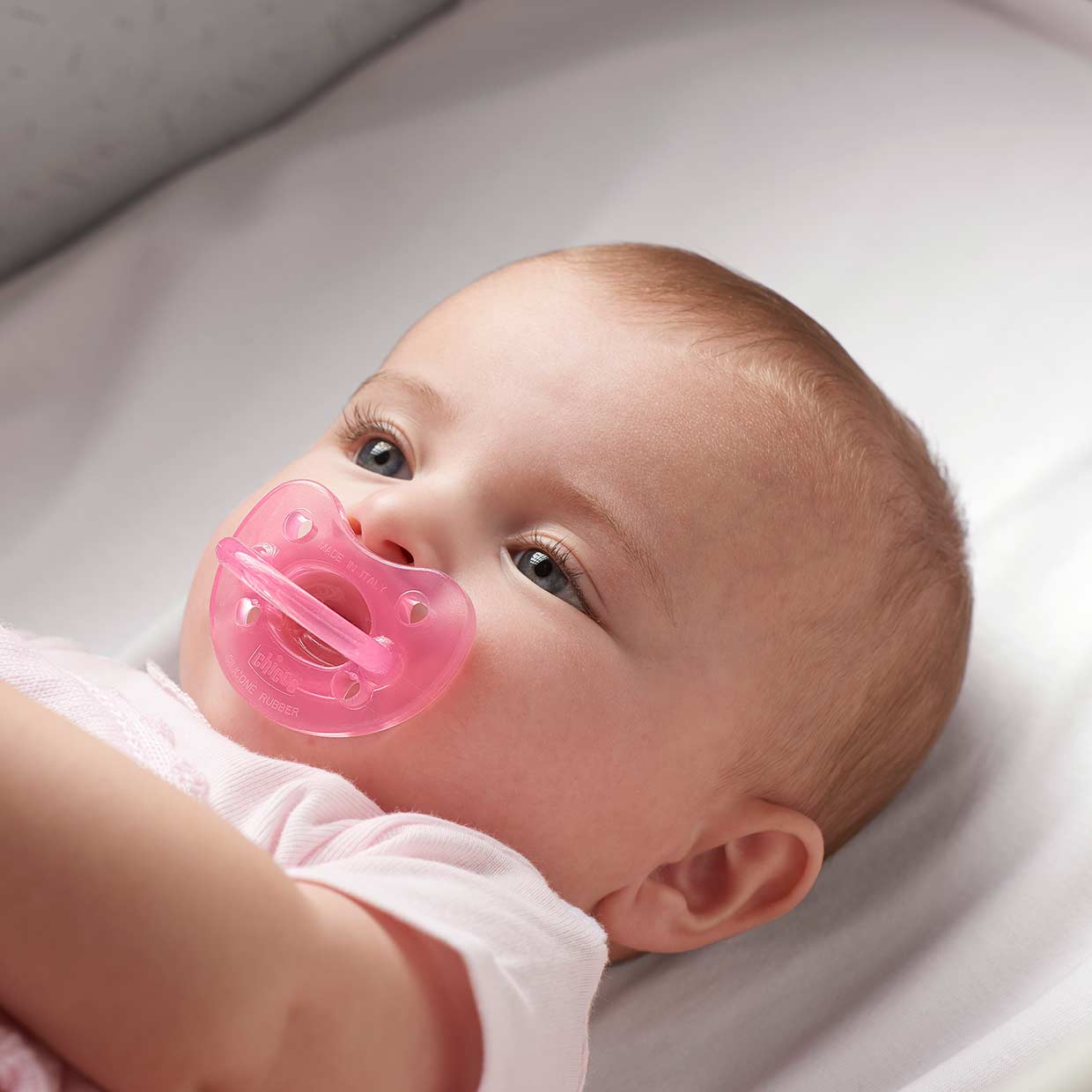 Chicco pink Pacifier and baby image
