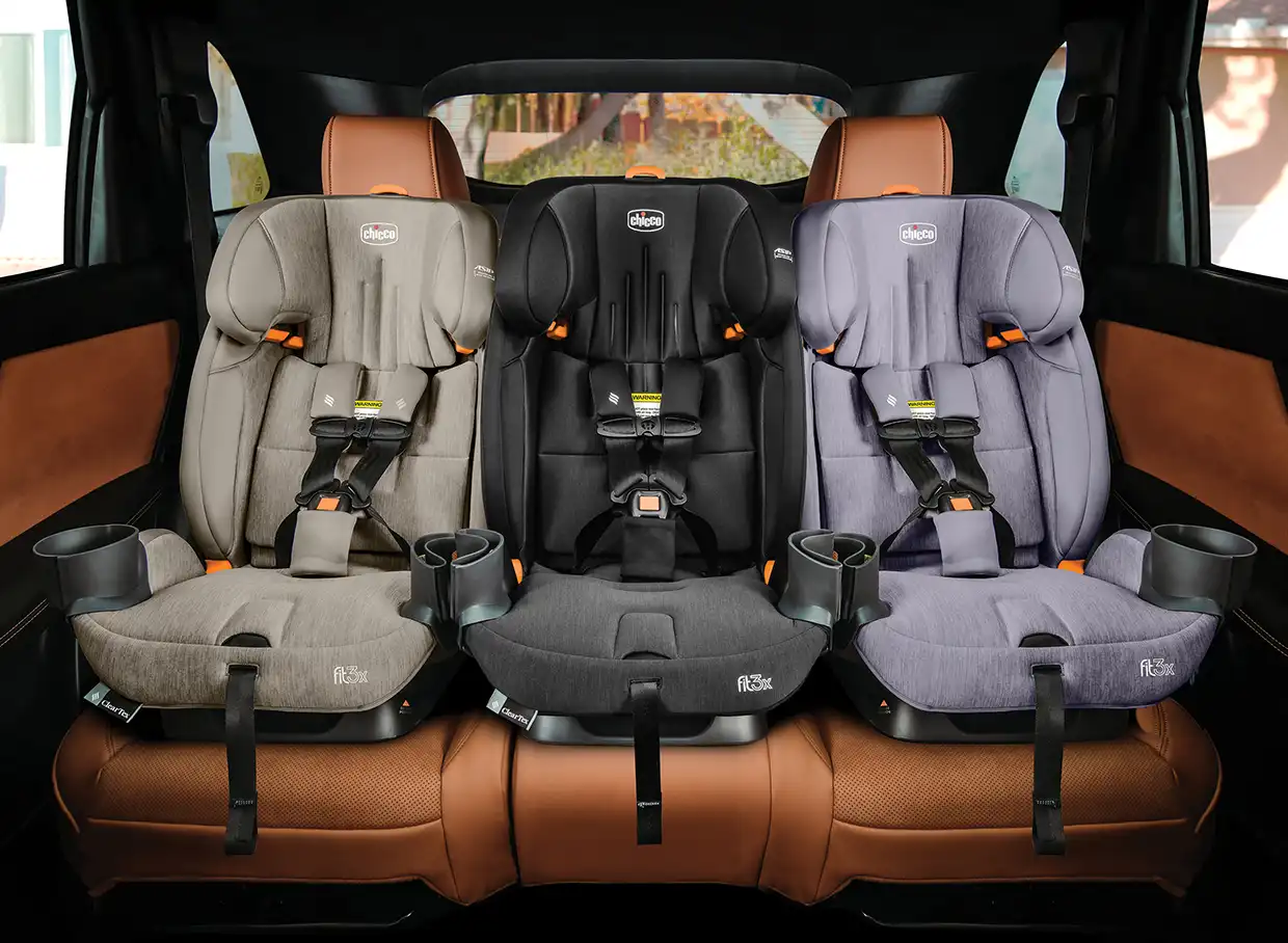 3 Chicco Fit3x car seats sitting side-by-side in the rear seat of a vehicle