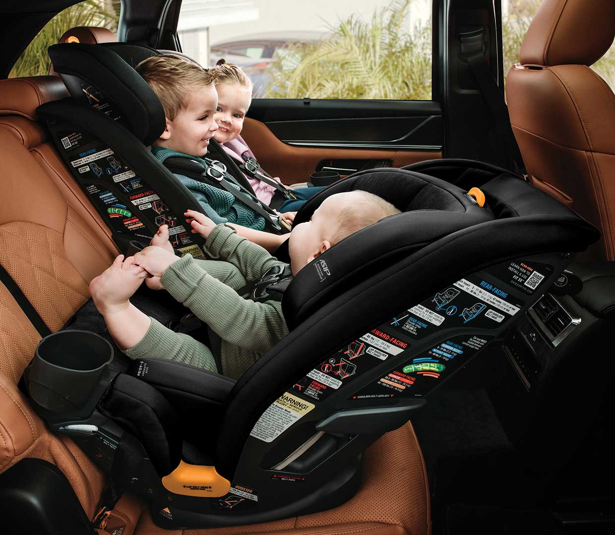 Boys in Chicco MyFit Car Seats sitting 3 across image