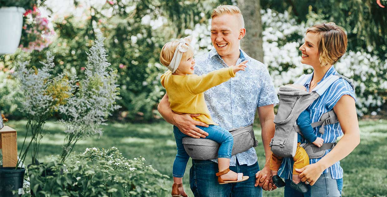 Parents with children using the Chicco SideKick and Hip Seat image