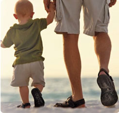 father and son walking along a beach