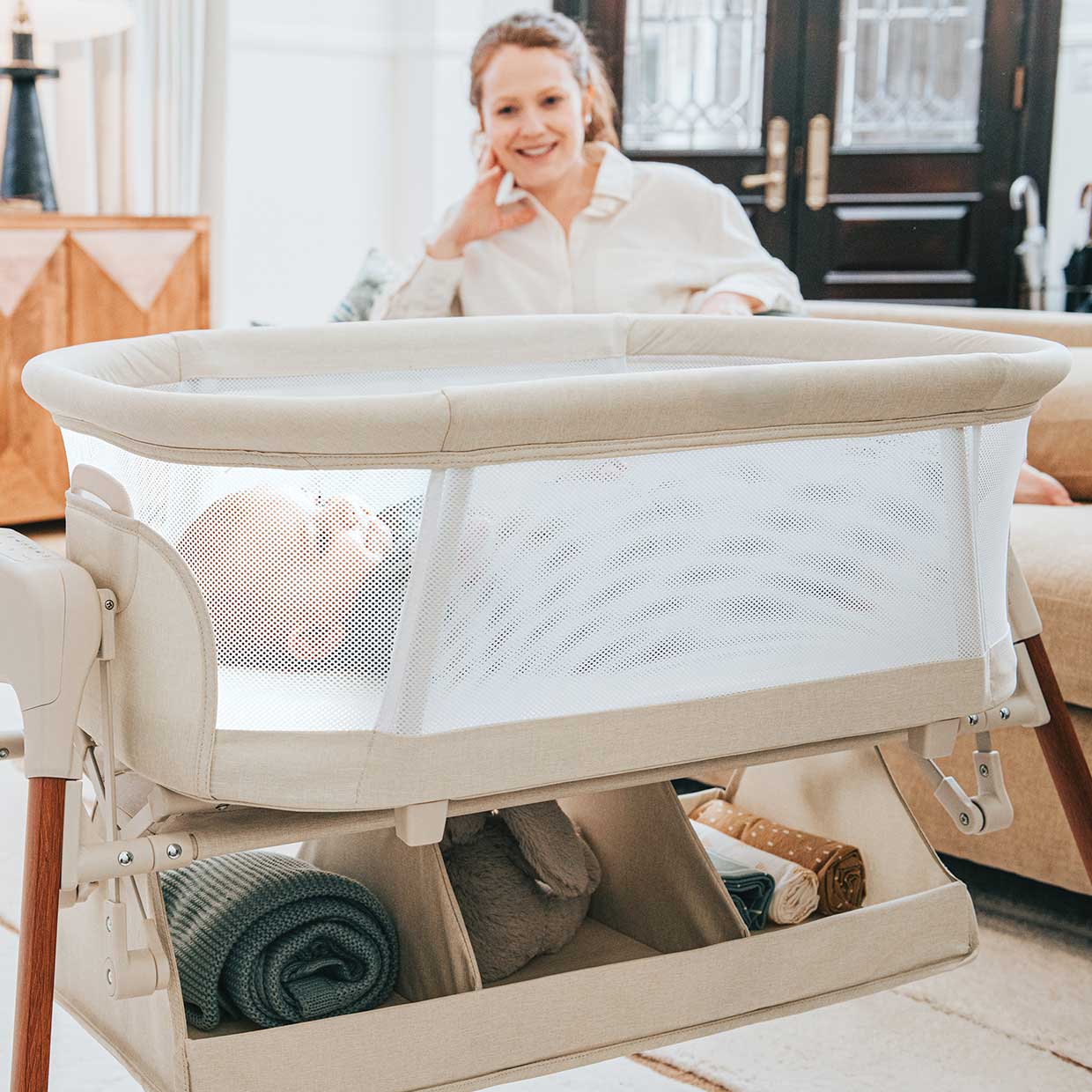 Mother with Chicco LullaGlide Plus 3-in-1 Bassinet in foreground