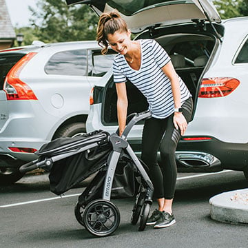 Woman folding the Chicco Bravo Stroller for easy car trunk storage
