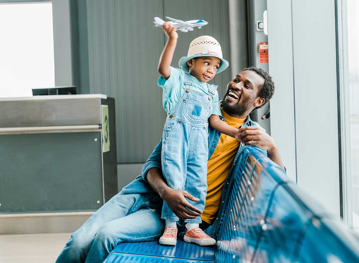 Dad and son playing with airplane at airport image