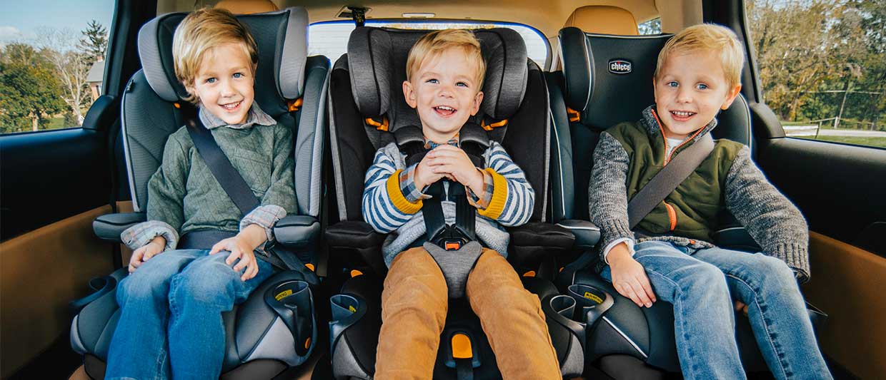 Boys in Chicco MyFit Car Seats sitting 3 across image