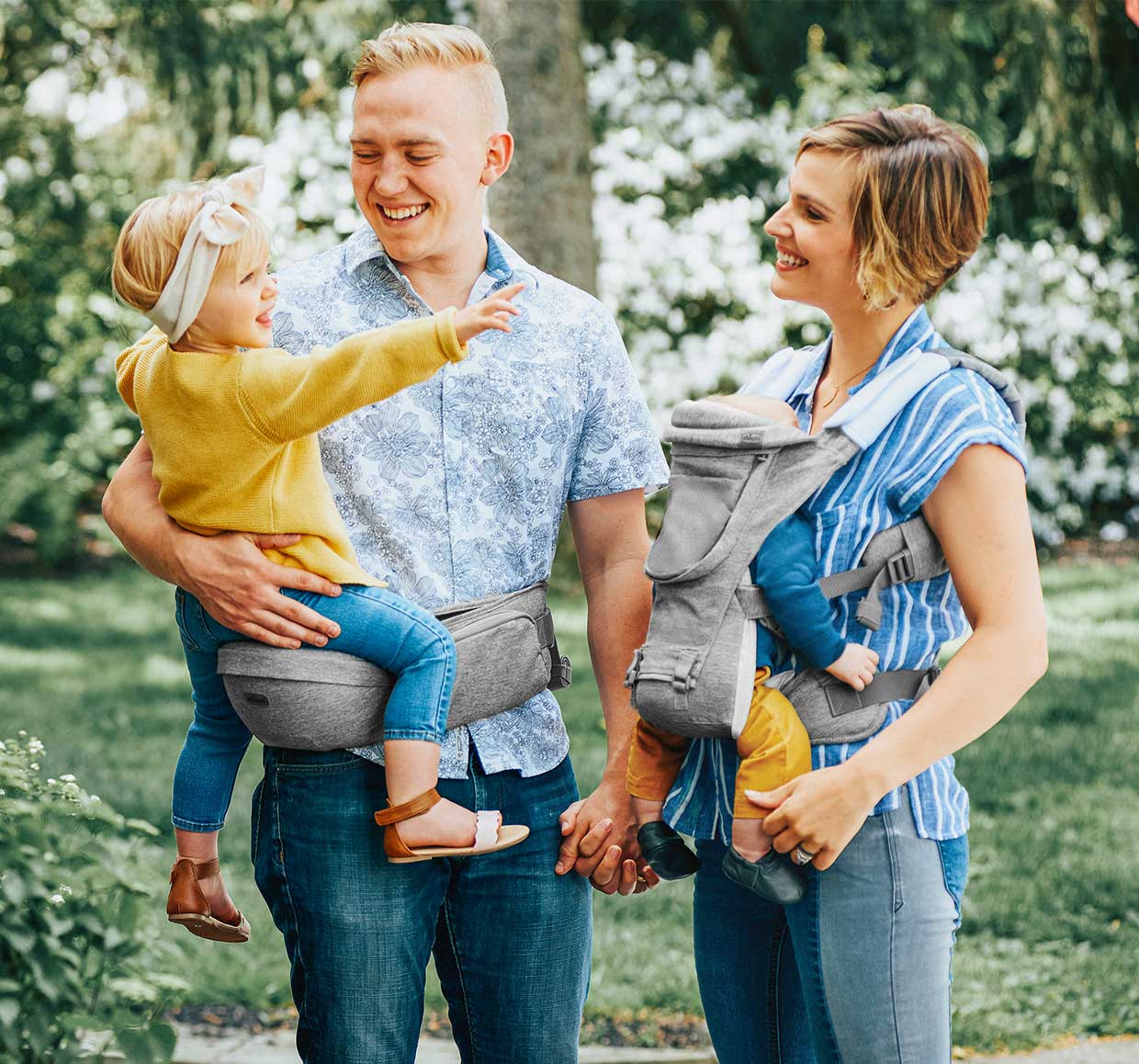 Parents with children using the Chicco SideKick and Hip Seat image