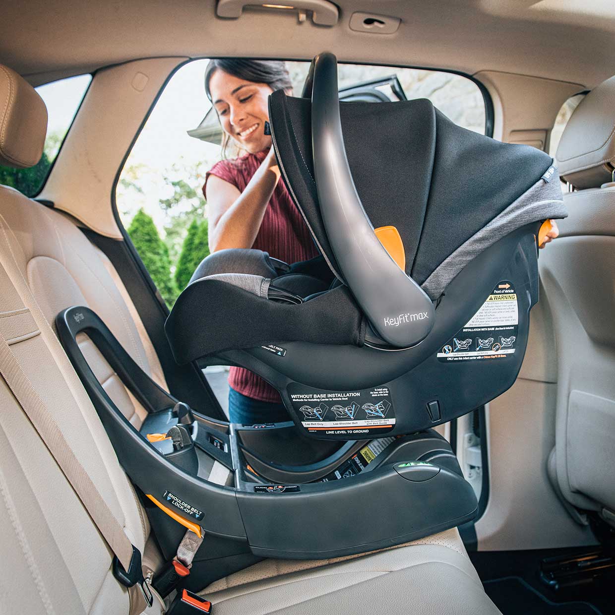 Mother installing a Chicco KetFit Max Infant Car Seat image
