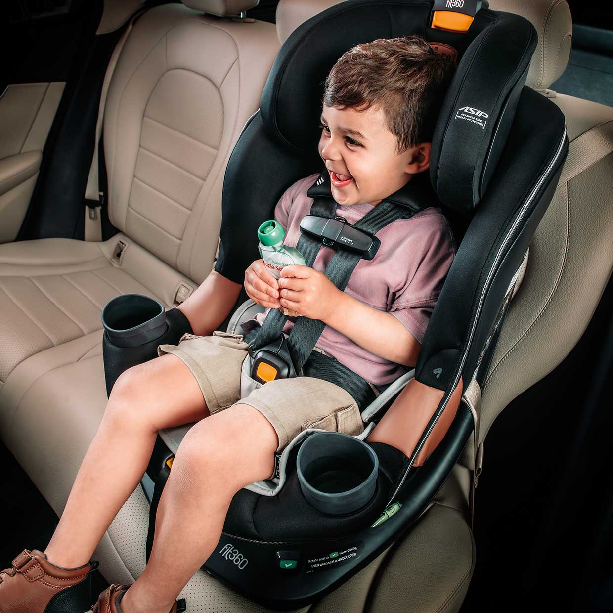 Toddler sitting in a Chicco OneFit LX ClearTex All-in-One Car Seat in forward-facing mode