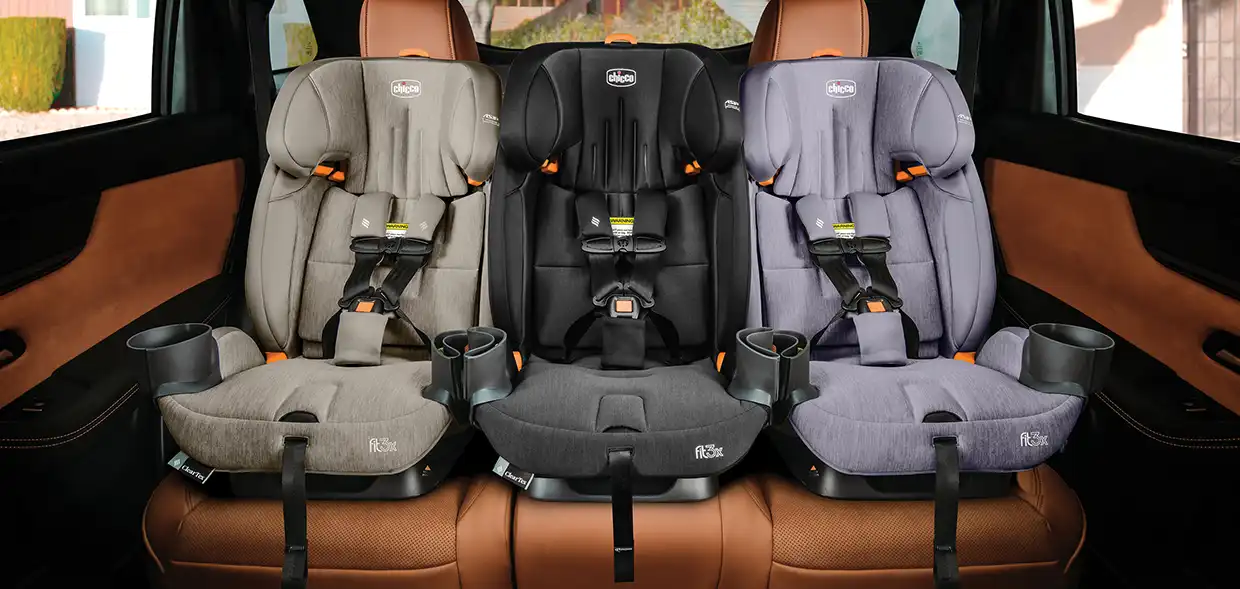 3 Chicco car seats sitting side-by-side in the rear seat of a vehicle