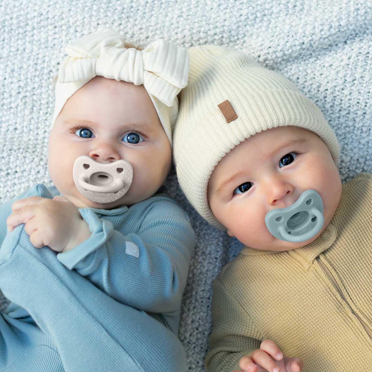 Two cute infant babies with pacifiers image