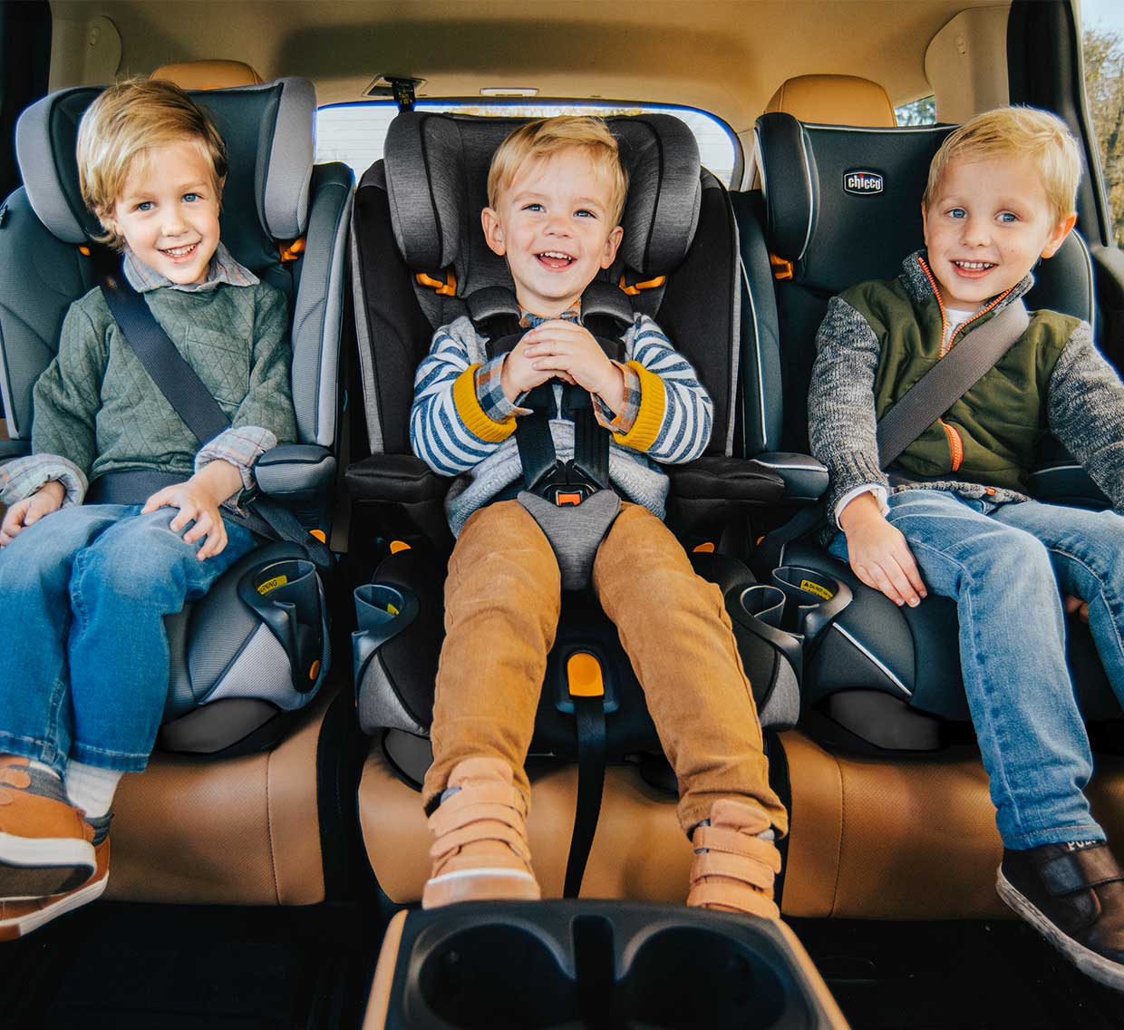 Boys in Chicco MyFit Car Seats sitting 3 across image