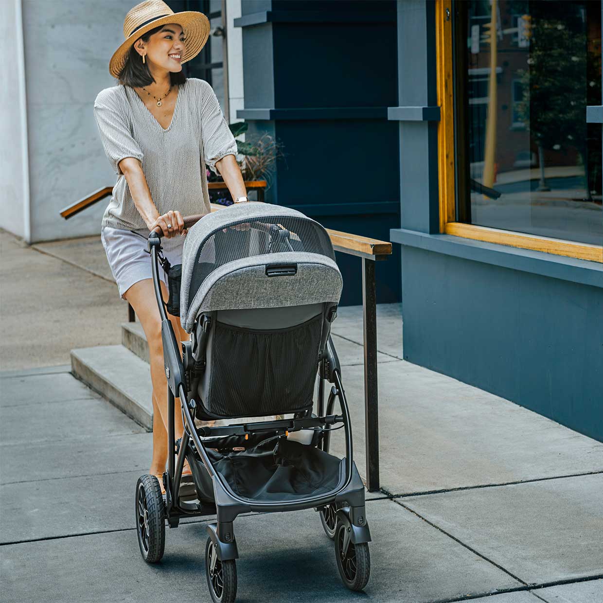 Mother pushing child in a Chicco Corso Primo stroller
