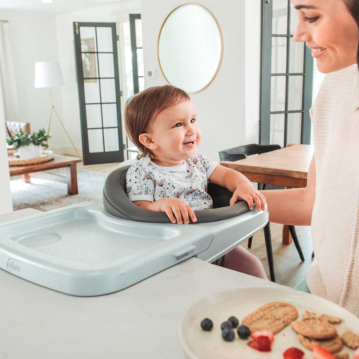 Mother with child using a Chicco FastLock 360 Hook-On Chair