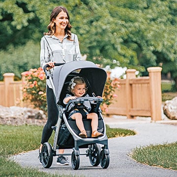 Mother pushing a toddler in a Chicco Bravo Stroller